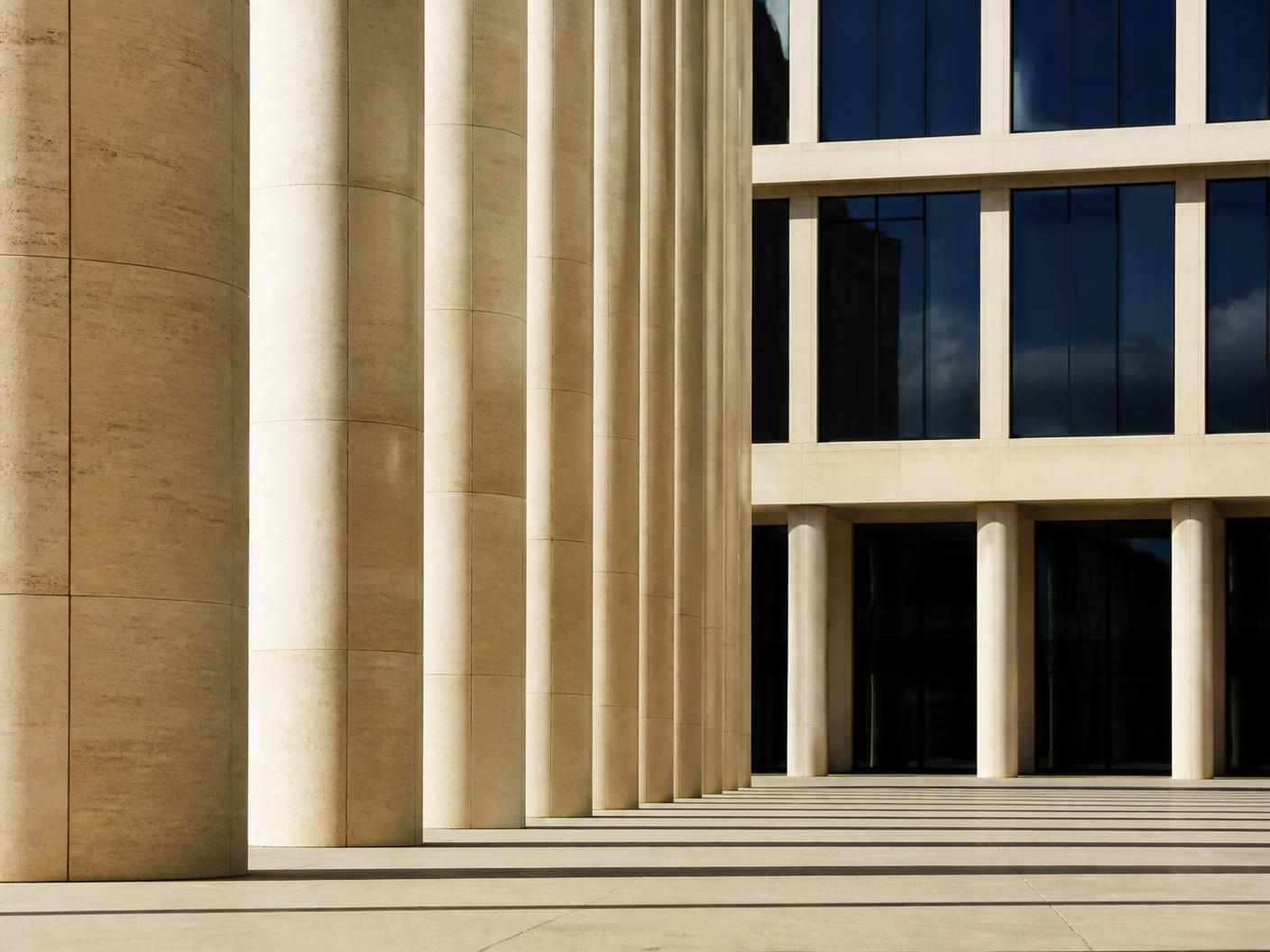 Limestone columns framing a modern institutional building